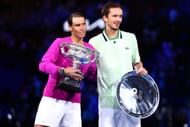 Rafael Nadal (L) and Daniil Medvedev pose during the trophy presentation for the Men’s Singles Final match at the 2022 Australian Open